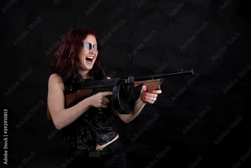Beautiful woman dressed in black jacket with a gun Beautiful woman dressed in black jacket with a gun