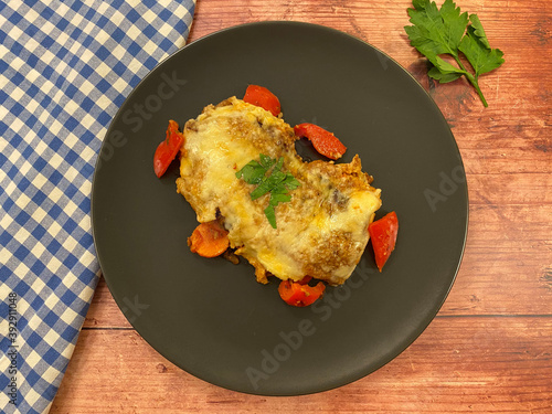 Hearty, stuffed pancakes, also known as Italian crespelle primavera pancakes, filled with vegetables and cheese gratin. Vegetarian food concept.