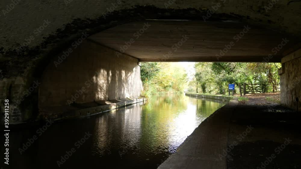 Under old canal bridge waterway sunny autumn reflections on wall with rainfall drizzle Under old canal bridge waterway sunny autumn reflections on wall with rainfall drizzle