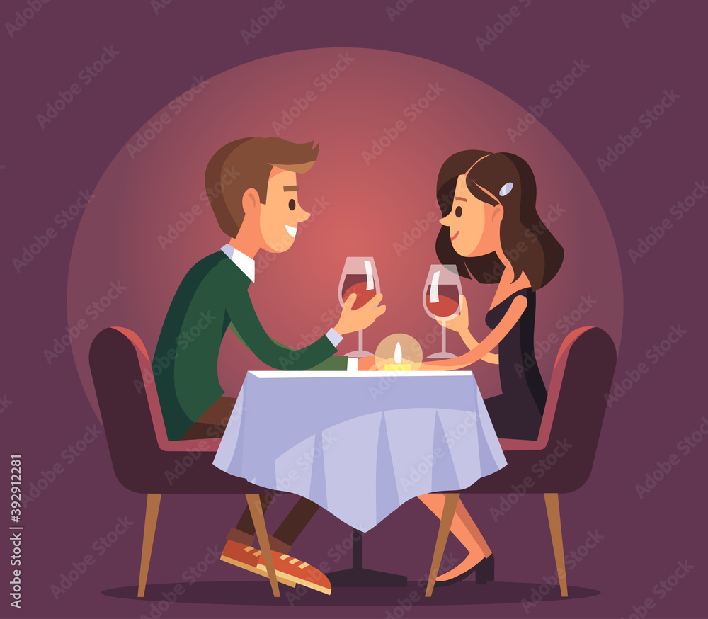Dating. Valentines day celebration. Sweet happy young couple having romantic dinner with glasses of red wine on date.Drink wine.Christmas evening celebration.Pair couple together at the dinner table.