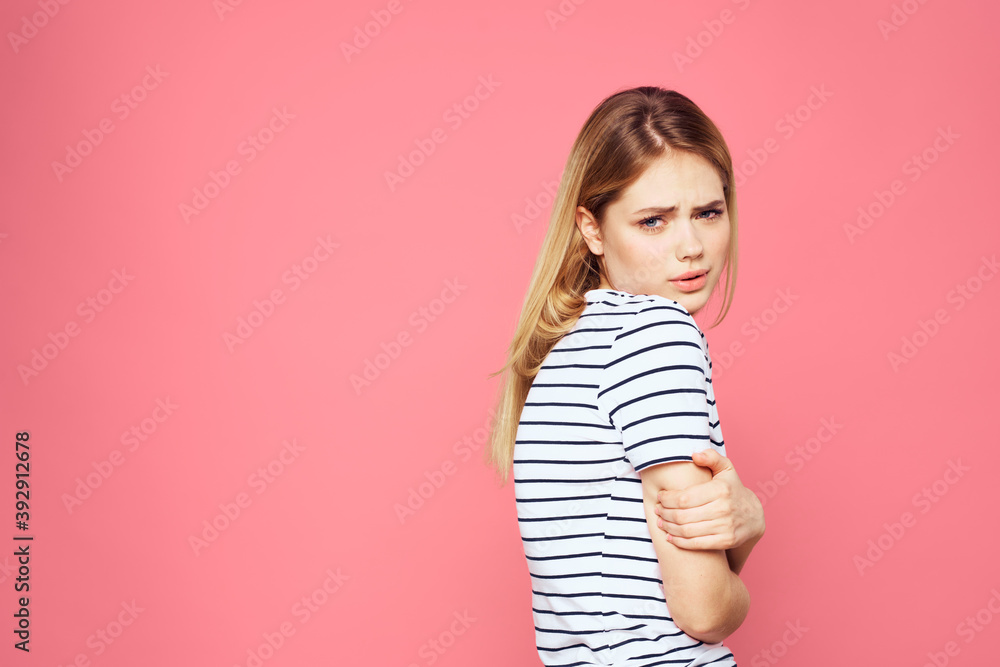 Woman in striped t-shirt emotions studio cropped view lifestyle pink isolated background Woman in striped t-shirt emotions studio cropped view lifestyle pink isolated background