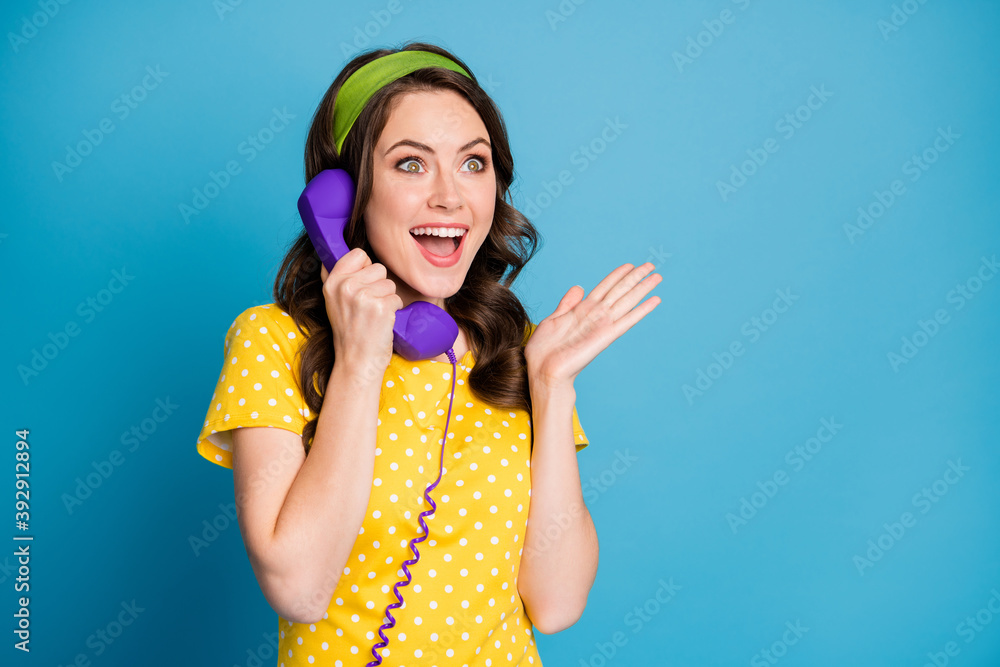 Photo portrait of excited girl hearing good news over purple telephone isolated on pastel light blue colored background Photo portrait of excited girl hearing good news over purple telephone isolated on pastel light blue colored background