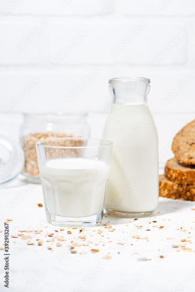 fresh milk and whole grain bread slices, vertical fresh milk and whole grain bread slices, vertical