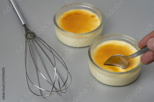 Fotografie Crème brûlée presentation with a spoon and egg beater