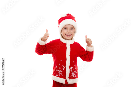 A smiling boy dressed as Santa Claus and in a good mood