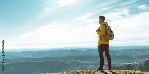 Hiker man on the top of the mountain looking the landscape view - Success, motivational and sport concept