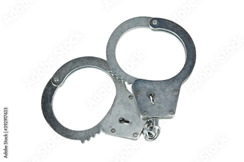 Handcuffs isolated on white background without shadows. Pair of real metal handcuffs macro close-up high resolution.