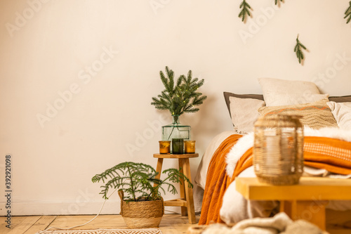 Christmas tree branches near the bed .Christmas interior. Christmas concept. Pillows, pine cones, gypsophila and fir tree branch