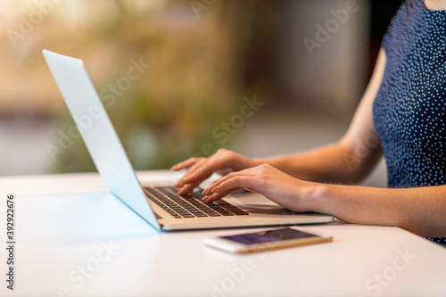 Young businesswoman using laptop in a modern office 