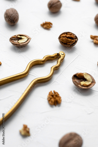 Walnut with nutcracker on white background