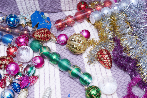 lots of Christmas ornaments and Christmas balls lies on the blanket. Flat lay. © Oleg Picolli
