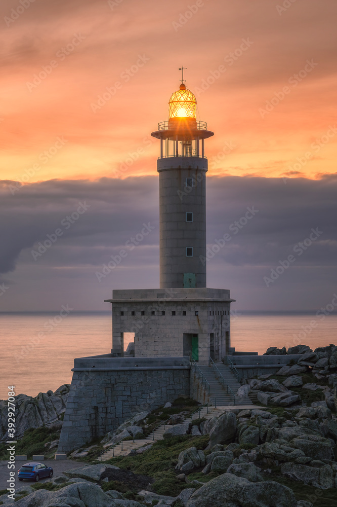 vertical image of punta nariga lighthouse at sunset in galicia in spain
