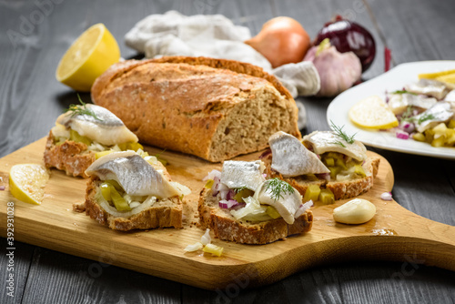 sandwiches with herring, onion and cucumber