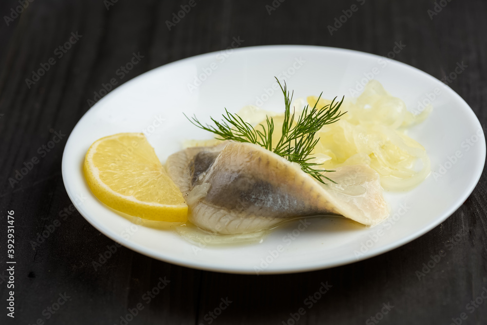 herring fillet with lemon slice and onion