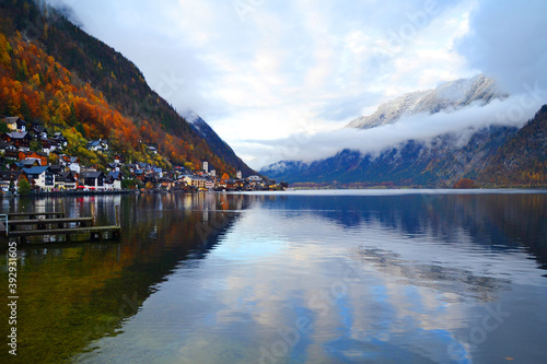 Hallstatt town view in a foggy day and clouds between the mountains. Amazing autumn cityscape, Austria, Salzkammergut region