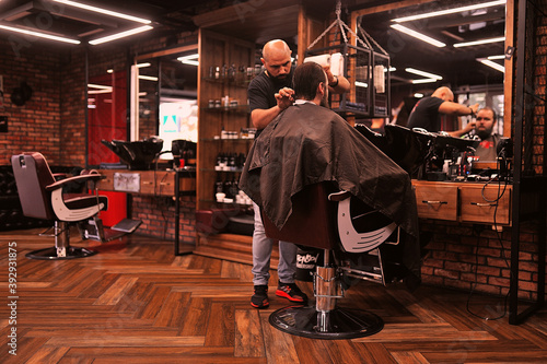 Brutal barber shaves a man in a barbershop