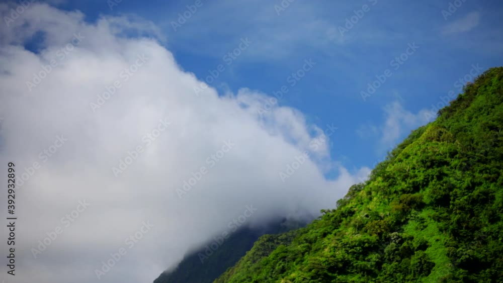 Low angle, clouds over tropical mountain in Tahiti Low angle, clouds over tropical mountain in Tahiti