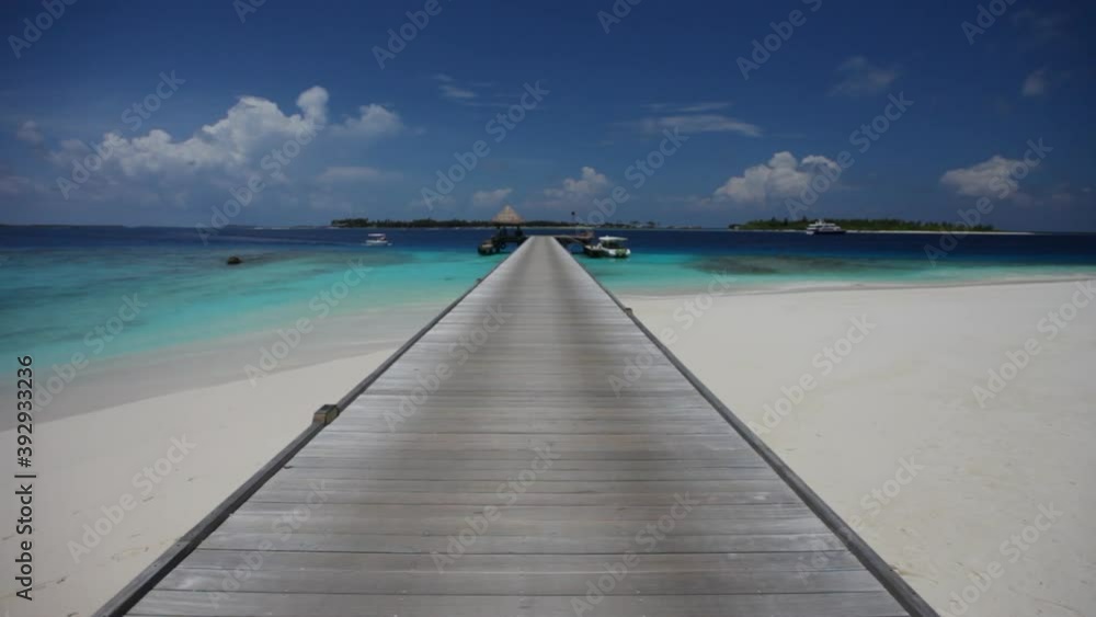 Wide, walking along wooden dock in Maldives Wide, walking along wooden dock in Maldives