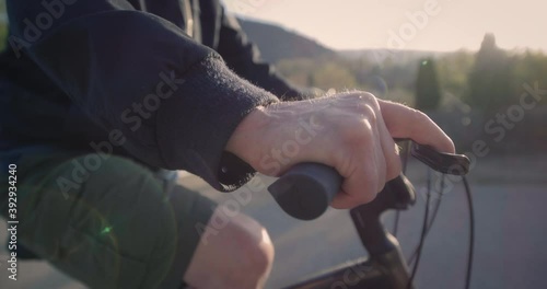 Close up, elderly man hand while on bike