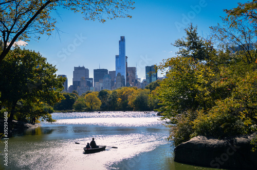 People rowing in boat in central park