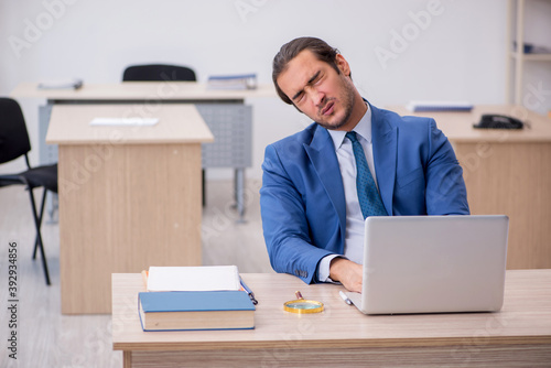 Young male employee and too much work in the office