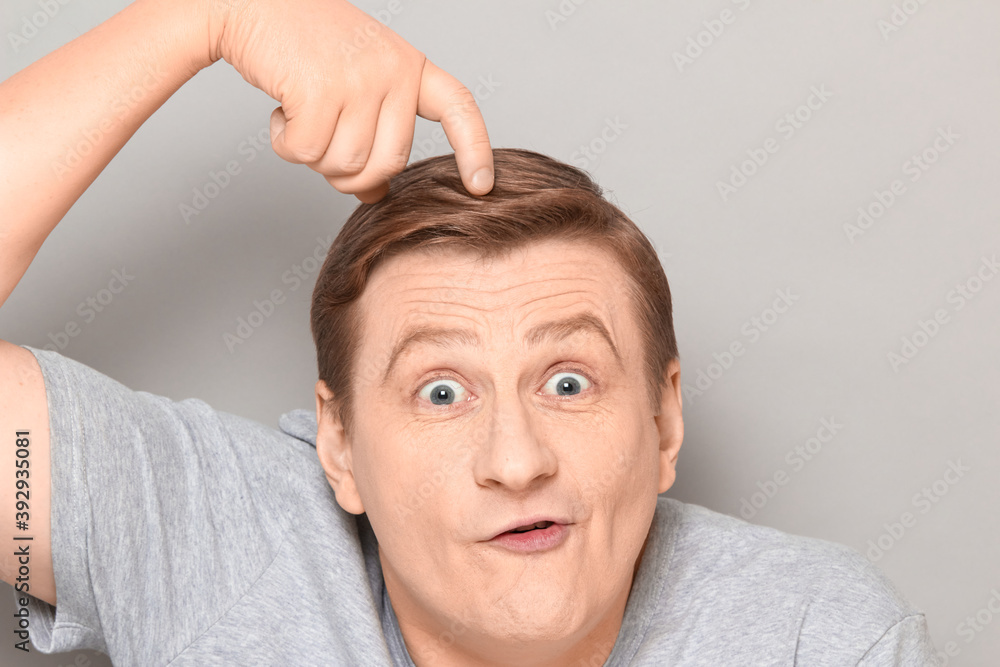 Portrait of funny optimistic man scratching head with finger Portrait of funny optimistic man scratching head with finger