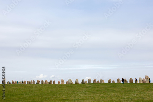 circle of stones, famous attraction ales stenar near Ystad, green grass and blue sky, kaseberga sweden  photo
