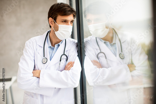 Male doctor looking away with worry  frustration  tiredness and exhausting feelings