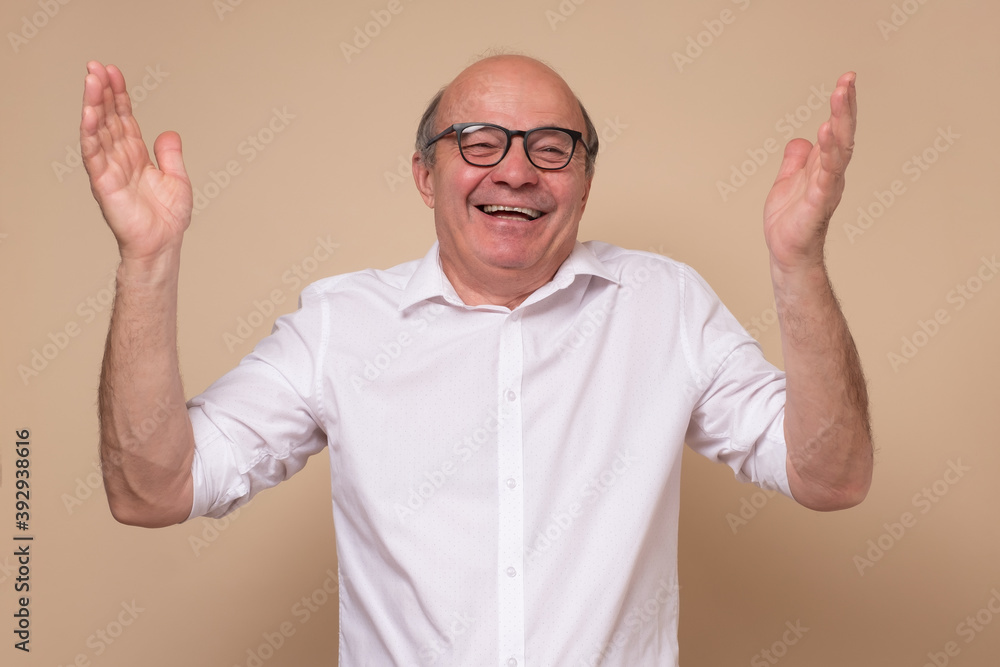 Senior hispanic man in glasses laughing on joke. Studio shot. Senior hispanic man in glasses laughing on joke. Studio shot.
