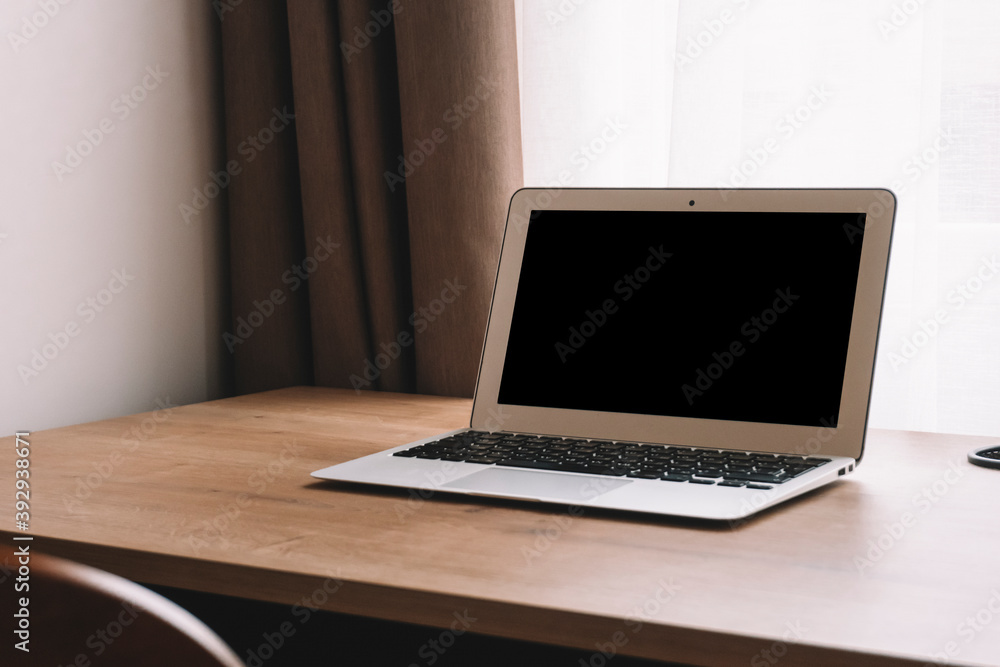 Laptop on work table in empty room or office. Off laptop with blank screen in the interior of the room. Laptop on work table in empty room or office. Off laptop with blank screen in the interior of the room.