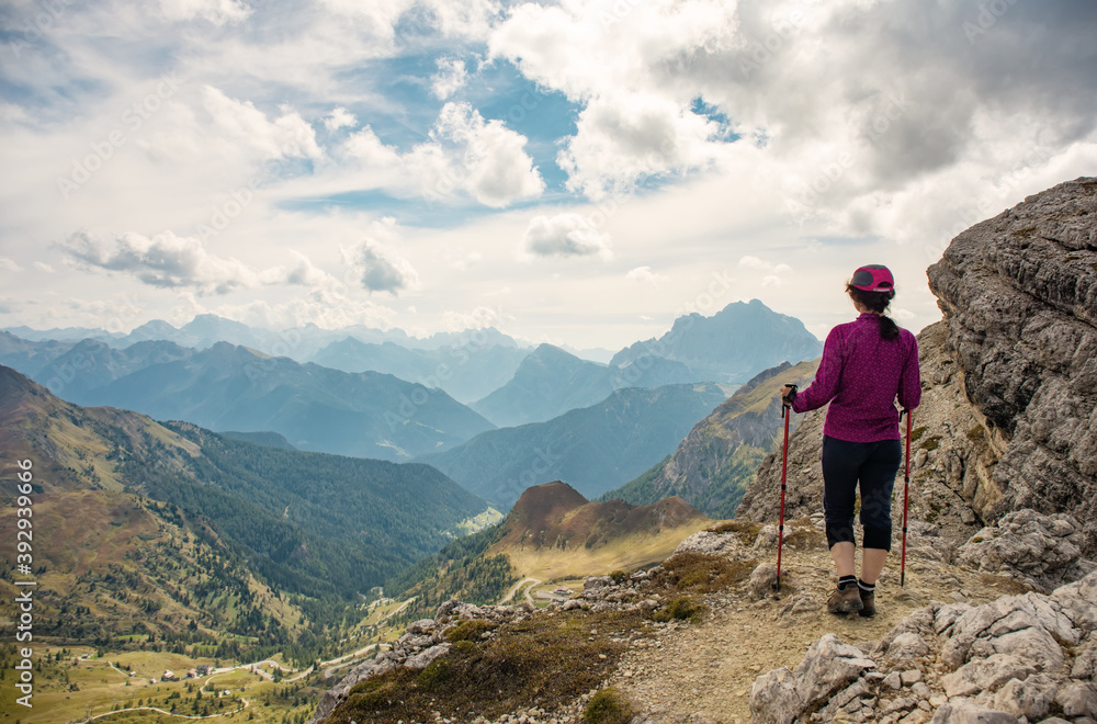 Sporty Young woman on mountain trail Dolomites Mountains, Italy. Sport, success, inspiration