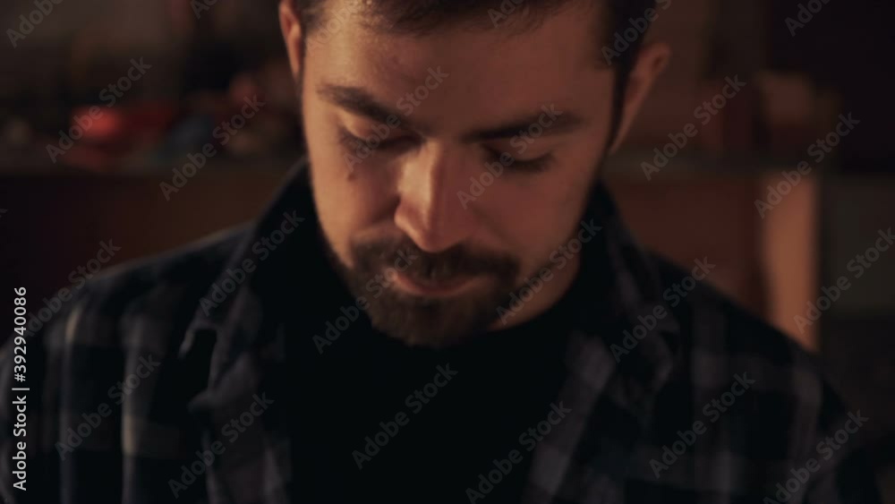 Portrait of smiling bearded man in low light Portrait of smiling bearded man in low light