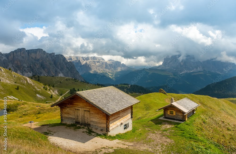 Summer view of Seceda Odle Puez mountain and wooden chalets in Dolomites, Trentino Alto Adige, South Tyrol, Italy