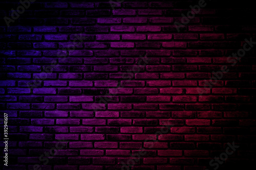 Neon light on brick walls that are not plastered background and texture. Lighting effect red and blue neon background vertical of empty brick basement wall.