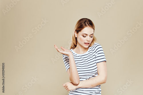 Cheerful woman striped t-shirt studio beige background lifestyle emotions