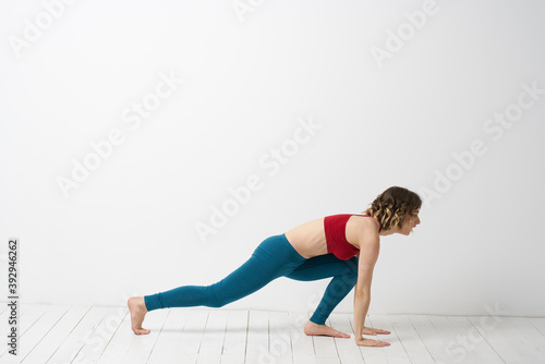 woman in leggings is engaged in gymnastics in a light room slim figure fitness sport