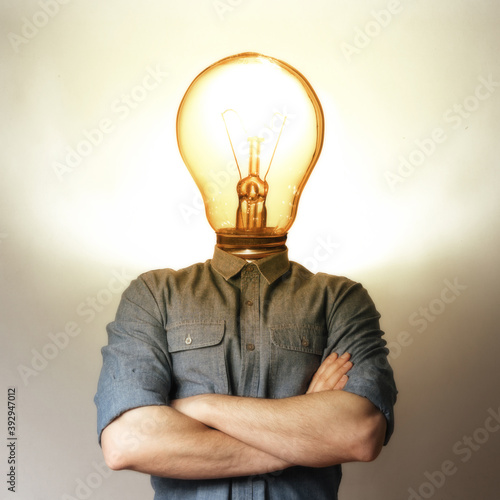 Concept of a new idea. A man with a light bulb instead of a head.