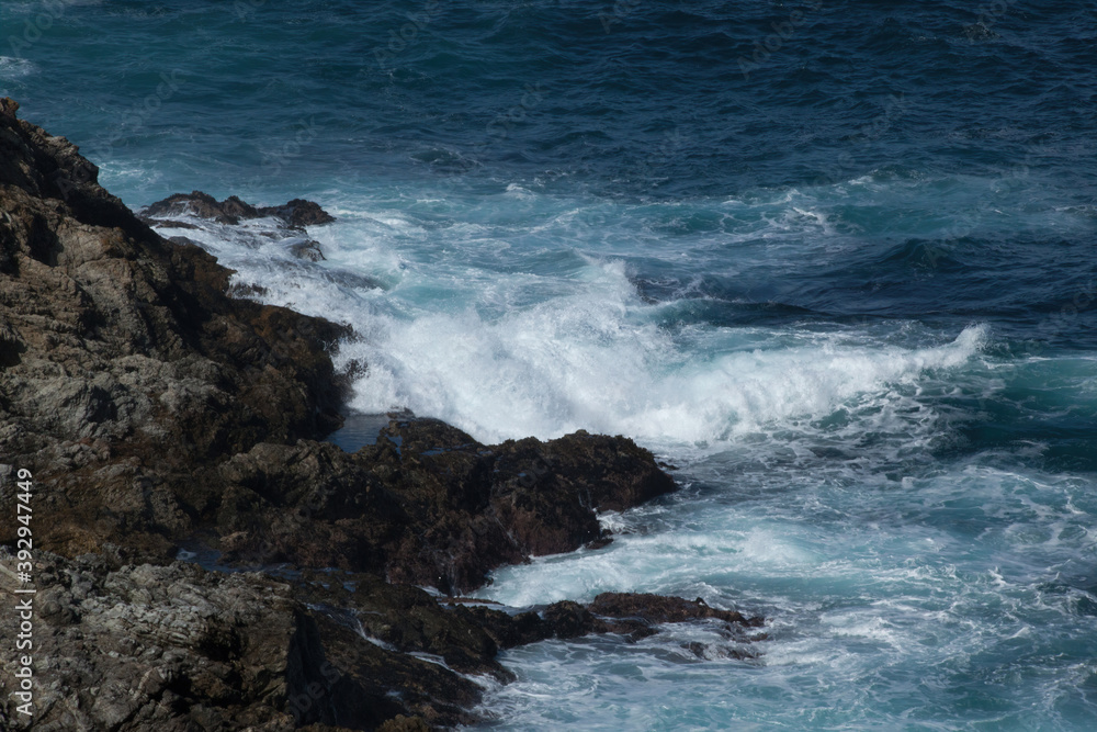 Ocean waves crashing onto a rocky shore Ocean waves crashing onto a rocky shore