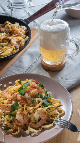 pasta with shrimps and beer in a glass