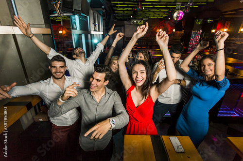 Young people dancing in night club