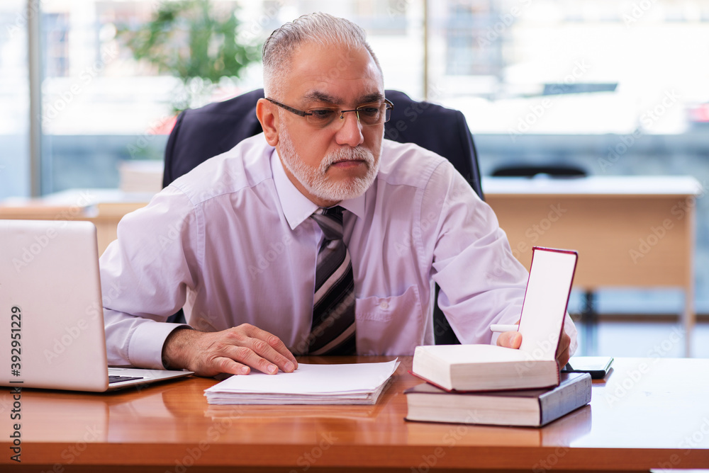 Old businessman employee working in the office Old businessman employee working in the office