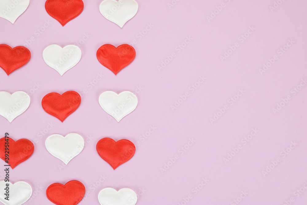 Red and white hearts on a pink background, arranged in three rows on the left side of the image