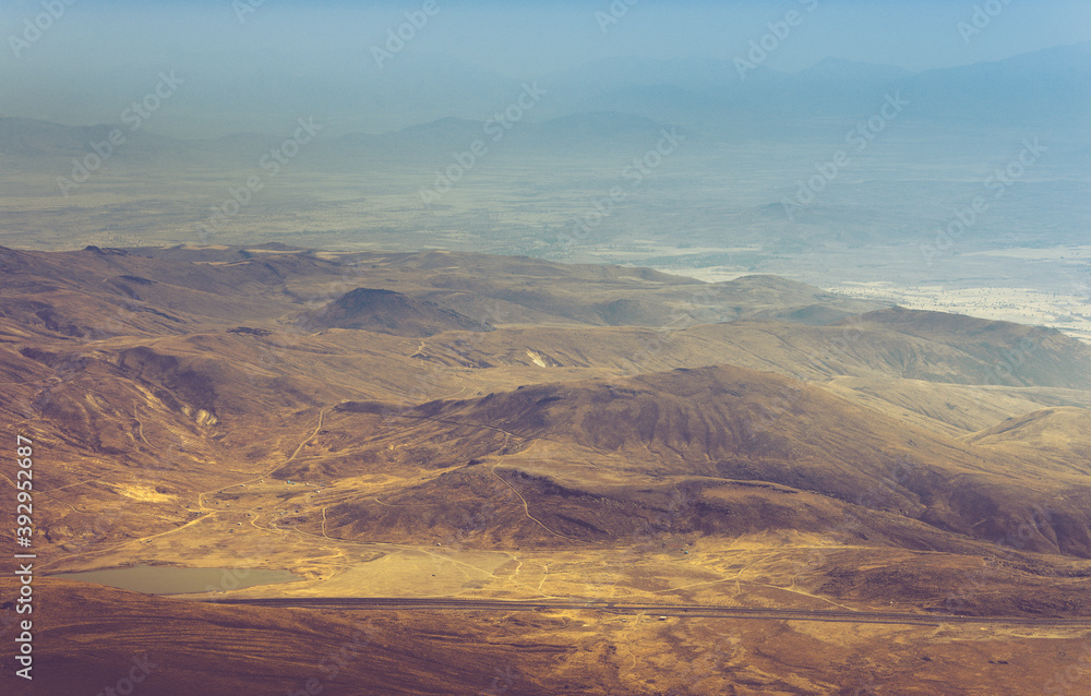 Amazing aerial view of desert, stone hills, and distant mountains layers range.Wilderness background. Vintage toning effect. Near Mount Erciyes. Kayseri, Turkey.