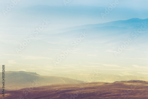 Amazing aerial view of desert, stone hills, and distant mountains layers range.Wilderness background. Vintage toning effect. Near Mount Erciyes. Kayseri, Turkey.