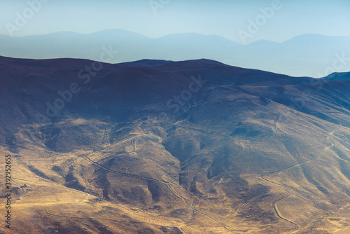 Amazing aerial view of desert, stone hills, and distant mountains layers range.Wilderness background. Vintage toning effect. Near Mount Erciyes. Kayseri, Turkey.