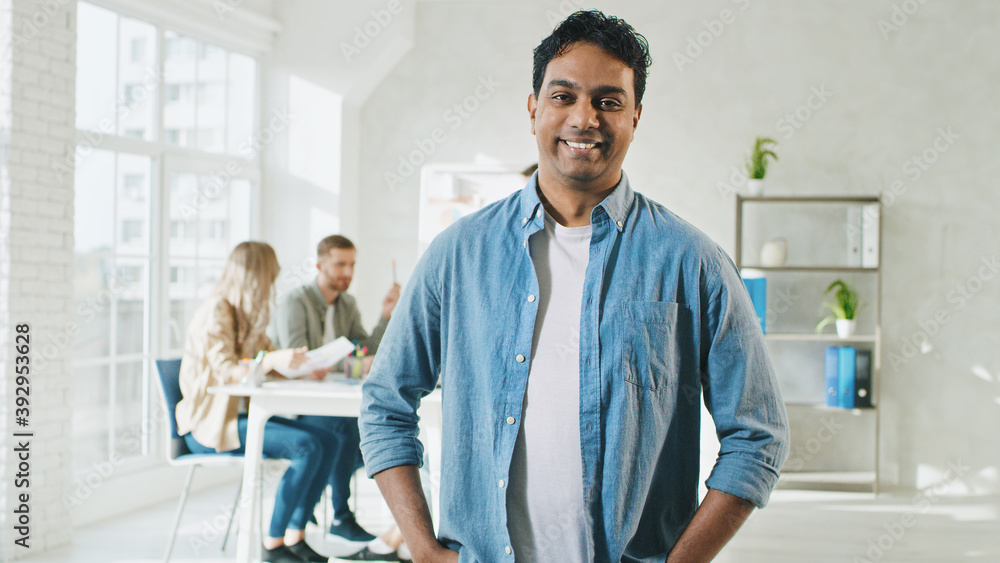 Indian Man Smilling at Work Portrait. Man in Creative Office. Sunny Day at Work in Office. Indian Man Smilling at Work Portrait. Man in Creative Office. Sunny Day at Work in Office.