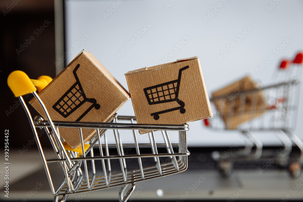 Boxes in a trollies on a laptop keyboard close-up. Online shopping concept.