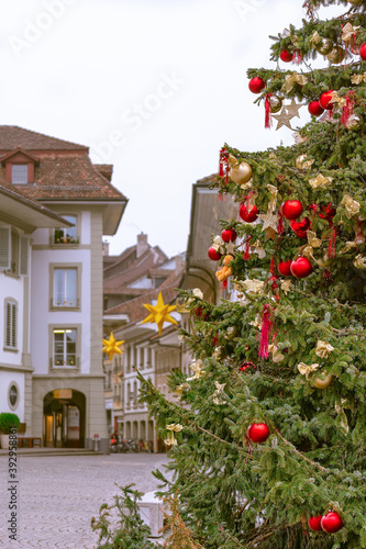 Christmas in Switzerland. Decorated Christmas tree on the background of a street in the Swiss city of Thun