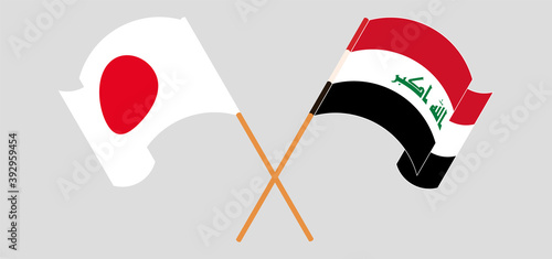 Crossed and waving flags of Japan and Iraq