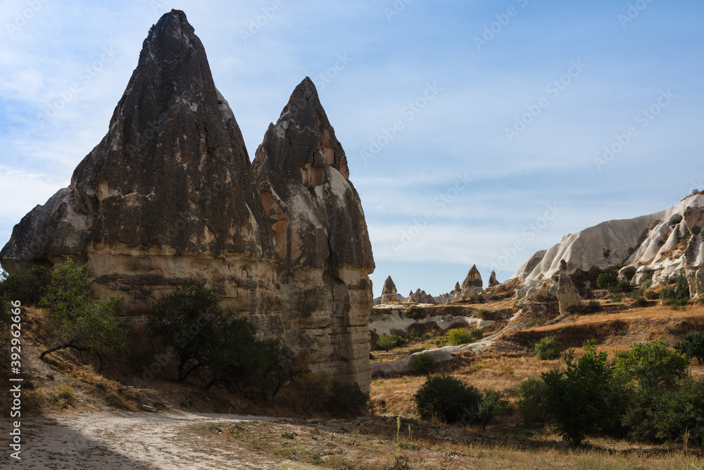Beautiful view of Goreme National Park, Turkey. The typical rock formations of Cappadocia with fairy chimneys, cave in hills and desert landscape. Top attraction travel destinations and adventure.